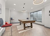 Thumbnail 22 of 37 - a spacious game room with a pool table and chairs