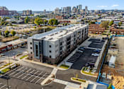 Thumbnail 30 of 37 - an aerial view of an apartment building in front of a city