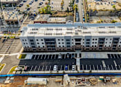 Thumbnail 29 of 37 - an aerial view of a large building in a parking lot