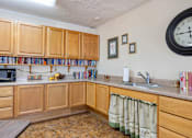 Thumbnail 5 of 16 - the kitchenette in the community room at Village Square Senior Apartments