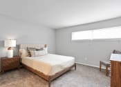 Thumbnail 9 of 14 - a bedroom with furnishings, a long narrow window, and plush carpeting at Mountainside Apartments