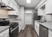 Thumbnail 19 of 28 - a kitchen with granite counter tops and stainless steel appliances