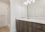 Thumbnail 6 of 37 - a bathroom with a sink and a mirror and a shower