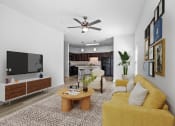 Thumbnail 9 of 57 - a living room with a yellow couch and a tv
