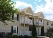 Thumbnail 2 of 18 - apartment exterior with established landscaping and mature trees