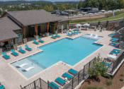 Thumbnail 20 of 43 - Canopy Park Apartments large swimming pool and sundeck with ample loungers at Canopy Park Apartments, Pelham, 35124