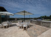 Thumbnail 21 of 43 - the grilling and picnic area on the sundeck at Canopy Park Apartments, Pelham, AL