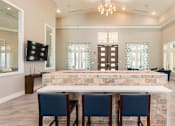 Thumbnail 7 of 30 - clubhouse leasing area with table and chairs
