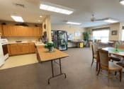 Thumbnail 6 of 24 - the community room and kitchenette area at Algonquin Manor