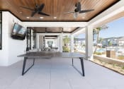 Thumbnail 18 of 48 - a ping pong table under ceiling fans at a relaxation deck at Lake Nona Concorde