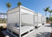 Thumbnail 14 of 48 - a row of white cabanas on Concorde's pooldeck with palm trees in the background