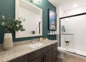 Thumbnail 39 of 48 - a bathroom with a toilet sink and shower with a glass door in Concorde apartment