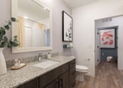 Thumbnail 41 of 48 - a bathroom with a toilet sink and mirror at Lake Nona Concorde