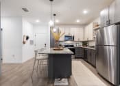 Thumbnail 32 of 48 - Kitchen with stainless steel appliances at Lake Nona Concorde