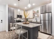 Thumbnail 33 of 48 - new apartment kitchen with stainless steel appliances, granite countertops, and pendant lights