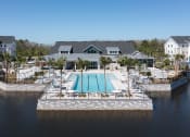 Thumbnail 46 of 48 - Lake Nona Concorde's pool, sundeck, and clubhouse beside the pond