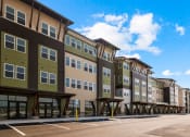 Thumbnail 39 of 43 - a row of new apartment buildings on the side of a street