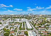 Thumbnail 31 of 40 - A cityscape with a mix of residential and commercial buildings under a clear sky.