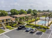 Thumbnail 10 of 37 - an aerial view of an apartment complex with a pool and parking lot