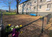 Thumbnail 24 of 24 - fenced dog park with flowers on the rails and a bench for people to use at The Flats at Jackson Square