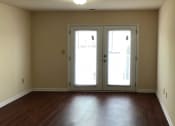 Thumbnail 8 of 18 - living room with hardwood-style floors and french doors
