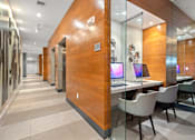 Thumbnail 8 of 40 - A modern office with wood paneling and glass walls.