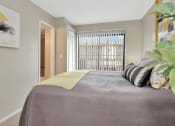 Thumbnail 23 of 32 - a bedroom with a large bed and a large window