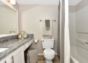 Thumbnail 26 of 32 - a bathroom with a white toilet next to a bathtub