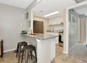 Thumbnail 18 of 32 - a breakfast bar with stools in the model home at The Oasis Apartments in Daytona Beach, FL