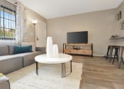 Thumbnail 15 of 32 - An apartment at The Oasis Daytona with a large window, wood-style floors, and model furnishings