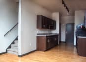 Thumbnail 9 of 12 - an empty kitchen with wooden floors and wooden cabinets