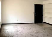 Thumbnail 6 of 8 - an empty bedroom with built-in shelving, a window, and door