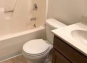 Thumbnail 8 of 8 - a bathroom with a toilet and a tub and a sink vanity