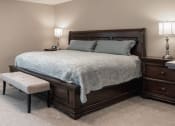 Thumbnail 7 of 8 - a bedroom plush pillows on a bed and two night stands with lamps and a bench