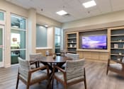 Thumbnail 3 of 26 - A modern dining room with a wooden table and chairs.