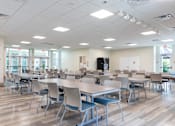 Thumbnail 8 of 26 - A large room with tables and chairs.