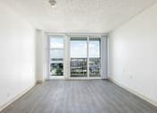 Thumbnail 13 of 26 - A room with a sliding glass door leading to a balcony.