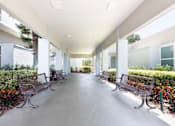 Thumbnail 21 of 26 - A long hallway with benches on either side.