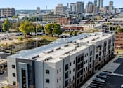 Thumbnail 37 of 37 - an aerial view of an apartment building with a city in the background