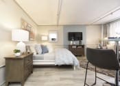 Thumbnail 16 of 24 - bedroom and living room area with model furnishings and designer paint