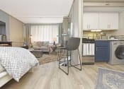 Thumbnail 3 of 24 - combo washer and dryer in kitchen and wood-style floors throughout