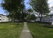Thumbnail 20 of 24 - Courtyard area with neat sidewalk and mature trees at The Flats at Jackson Square