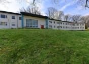 Thumbnail 21 of 24 - Lush green lawn and mature trees outside of The Flats at Jackson Square