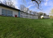 Thumbnail 22 of 24 - Lush green lawn and mature trees outside of The Flats at Jackson Square