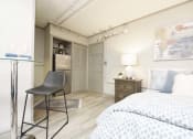 Thumbnail 17 of 24 - bed, small dining area, and kitchen in studio apartment at The Flats at Jackson Square