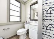 Thumbnail 18 of 24 - shower in bathroom with vanity, mirror, toilet, and window