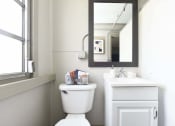 Thumbnail 19 of 24 - bathroom with toilet, sink, mirror, and window