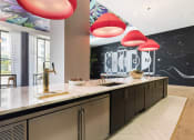 Thumbnail 5 of 42 - communal kitchen and bar in Pixon's clubhouse at Lake Nona Pixon, Orlando, FL