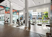 Thumbnail 6 of 40 - A gym with a variety of exercise equipment including treadmills, stationary bikes, and rowing machines.