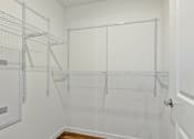 Thumbnail 24 of 57 - an empty closet in a home with white walls and glass doors